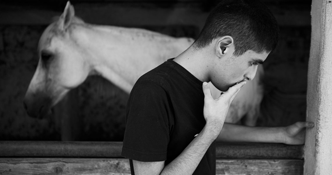 Italy, Succivo (CE), 17/07/2015. Gennaro, one of the two autistic twins, in a riding school during a closing moment. The horse represents a very important animal for the boys and their family. The twins in fact do not speak and the only time that Maurizio, one of the two spoke, said the word 