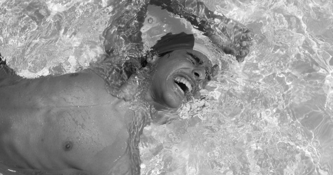 Italy, Licola (NA), 01/08/2013. Gennaro, one of the two autistic twins, swims during the summer camp of the Association La Forza del Silenzio. Gennaro loves contact with water. During the summer, the Association organizes the summer camp for all the autistic boys who take care of taking them to the swimming pool and organizing games that can keep them entertained and spend some beautiful summer days and thus support the families of the boys in the management of their children .